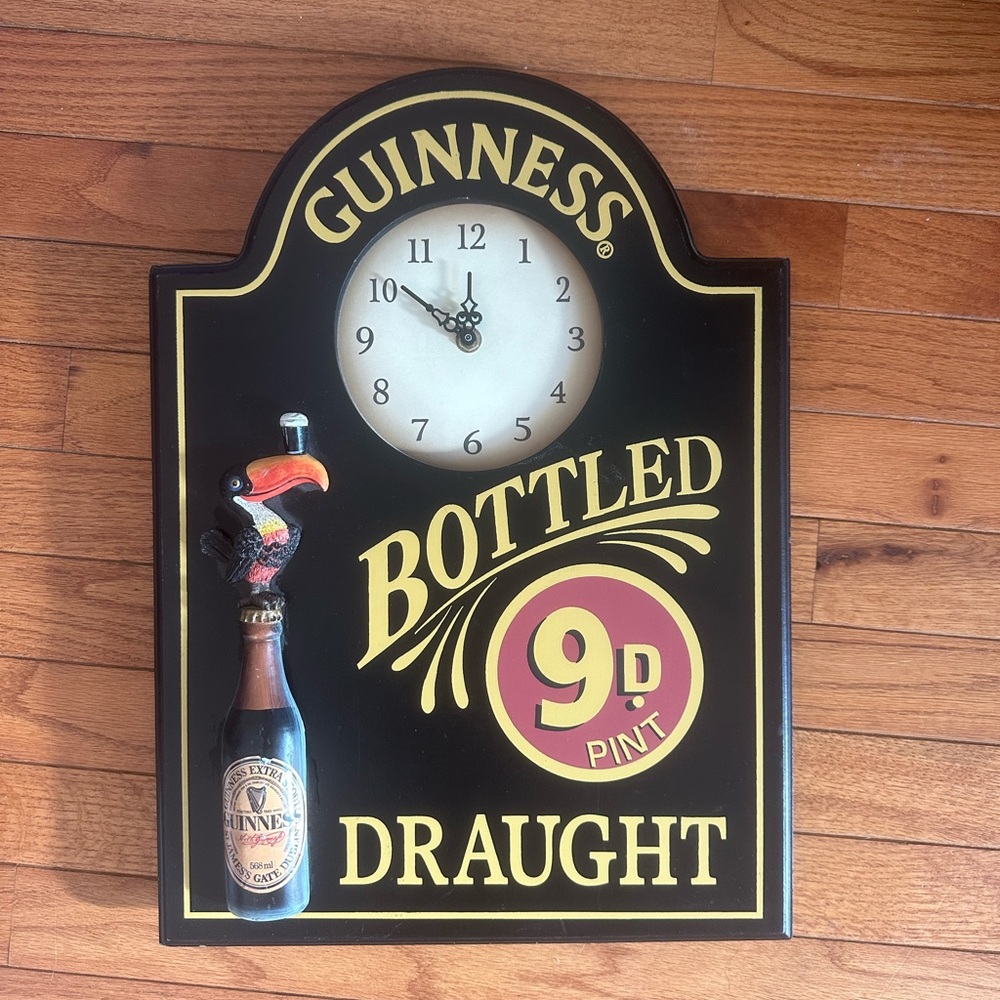 Guinness Black Wall Clock with Gold and Red Accents